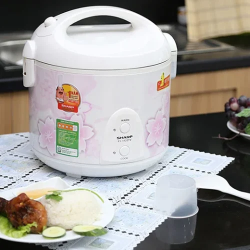 Nồi cơm điện Sharp KS-N192ETV SP 1.8 lít màu trắng hồng đặt trên bàn ăn