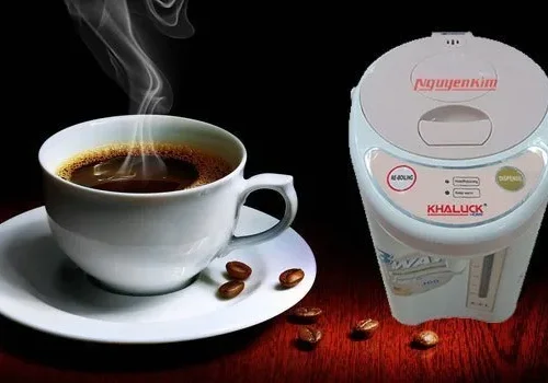 Bình thủy điện Khaluck KL-945 đặt cạnh tách cà phê